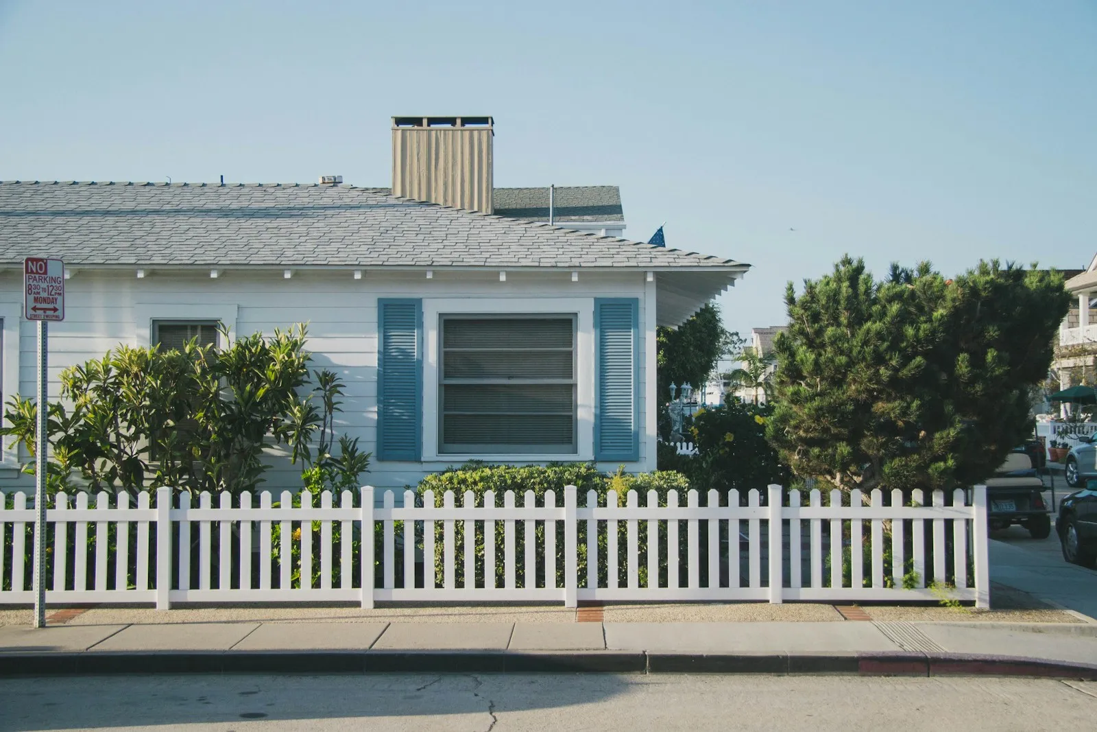 White picket fence in front of a cottage
